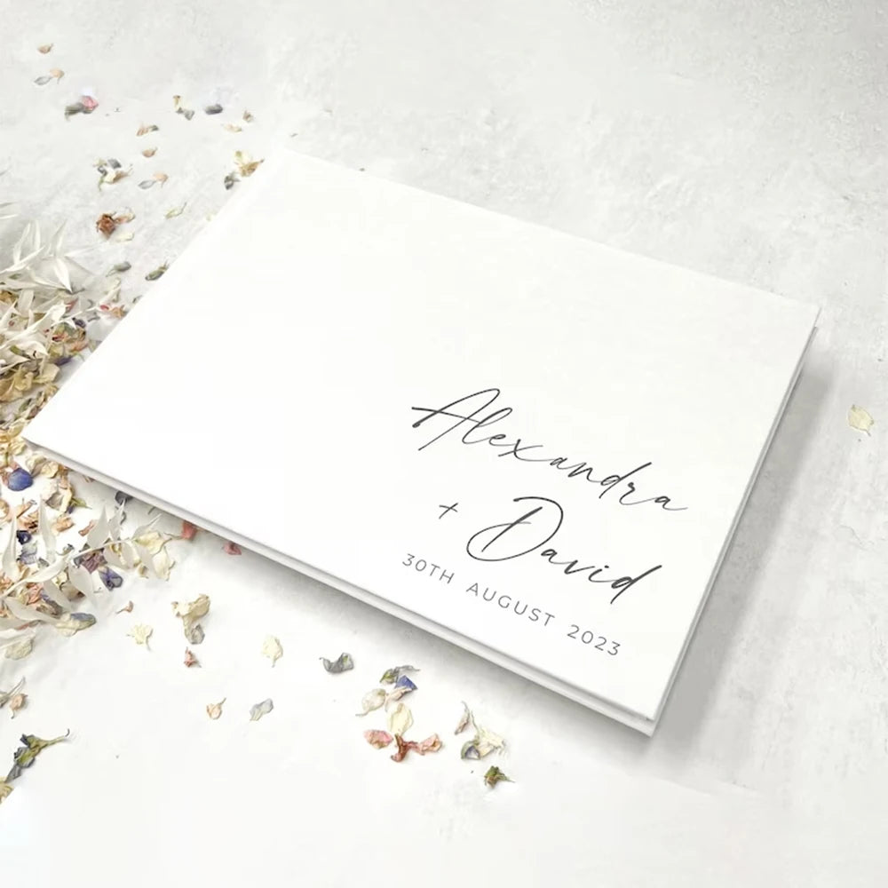 Elegant white wedding guest book with gold foil personalization