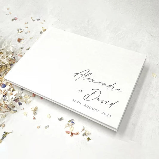 Elegant white wedding guest book with gold foil personalization